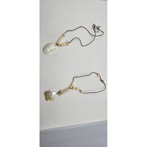 2 conch necklaces, one beach scene, one flower